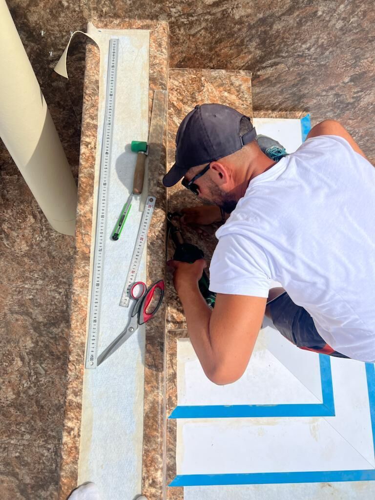 Gros plan sur la découpe précise du PVC armé sur un escalier